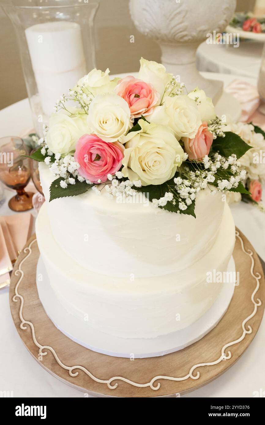 Wedding Cake with flower decorations on a table. Stock Photo