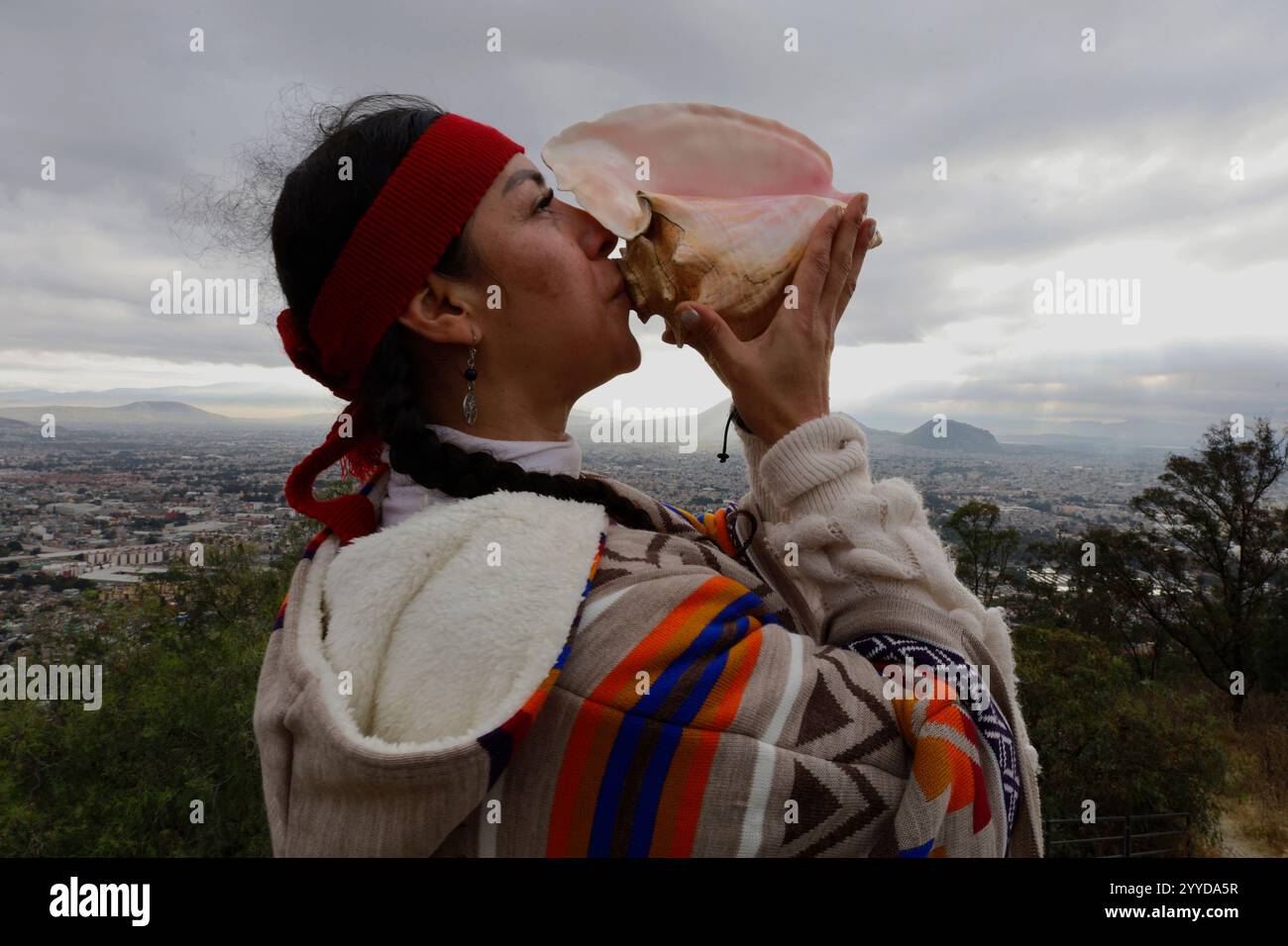 Mexico City, Mexico. 21st Dec, 2024. A dancer plays the conch shell on ...