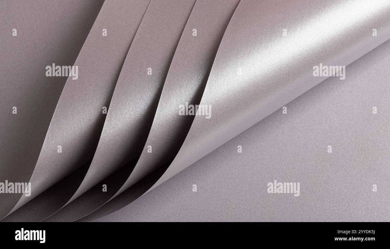 Soft gray paper texture with a metallic, glossy finish in taupe, sepia, and grayish pink with a subtle pink undertone. The shimmering gradient and sle Stock Photo