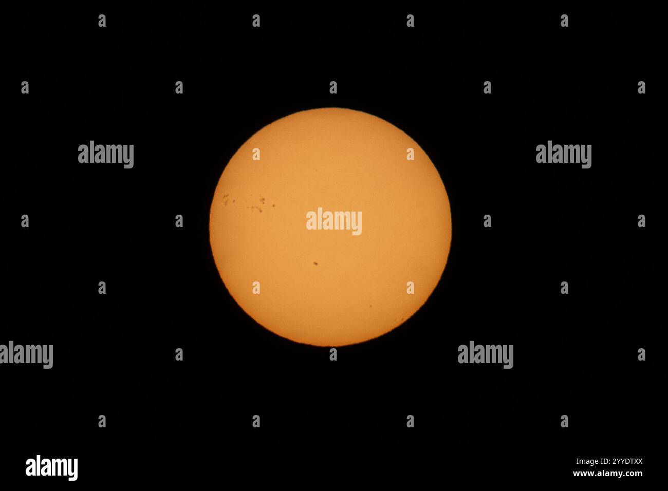 View of the sun with visible sunspots during the Winter Solstice. The