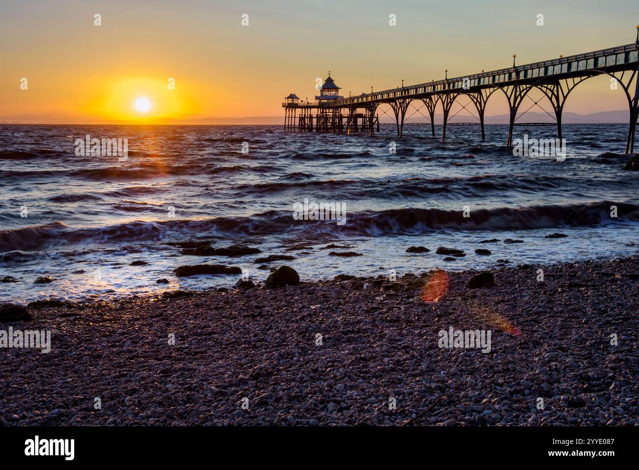 Clevedon Pier In The Golden Hour At Sunset With Sunlit Shoreline And clevedon-pier-in-the-golden-hour-at-sunset-with-sunlit-shoreline-and
