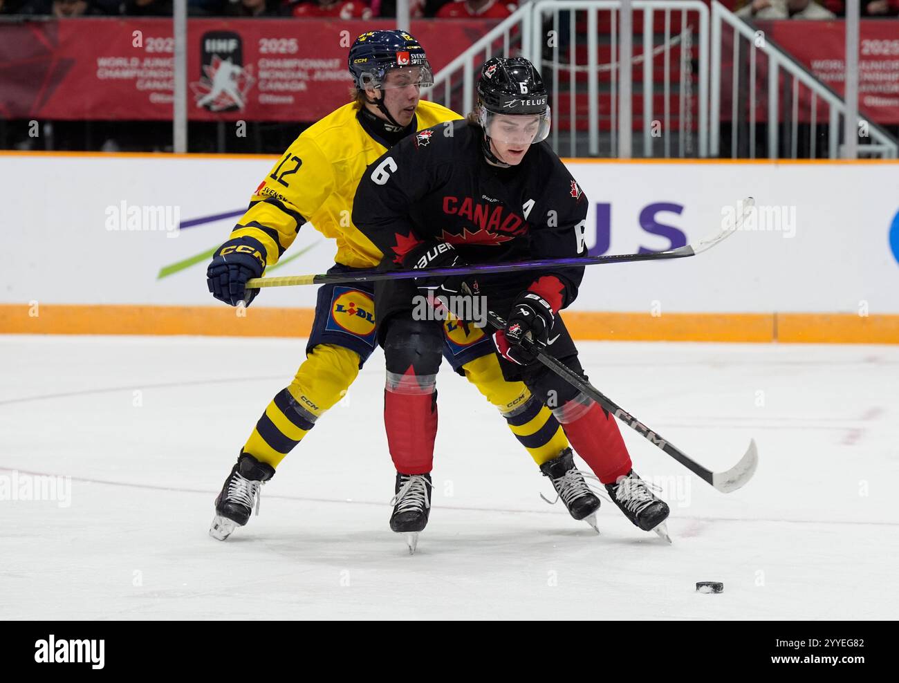 Sweden forward Isac Hedqvist tries to get the puck from Canada