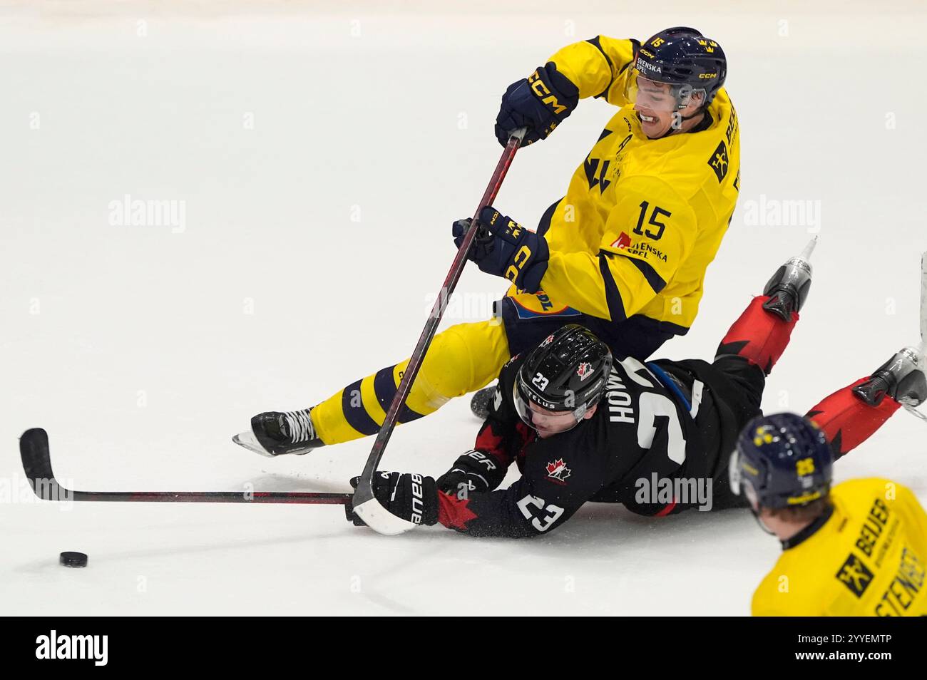 Canada forward Tanner Howe knocks the puck away from Sweden forward
