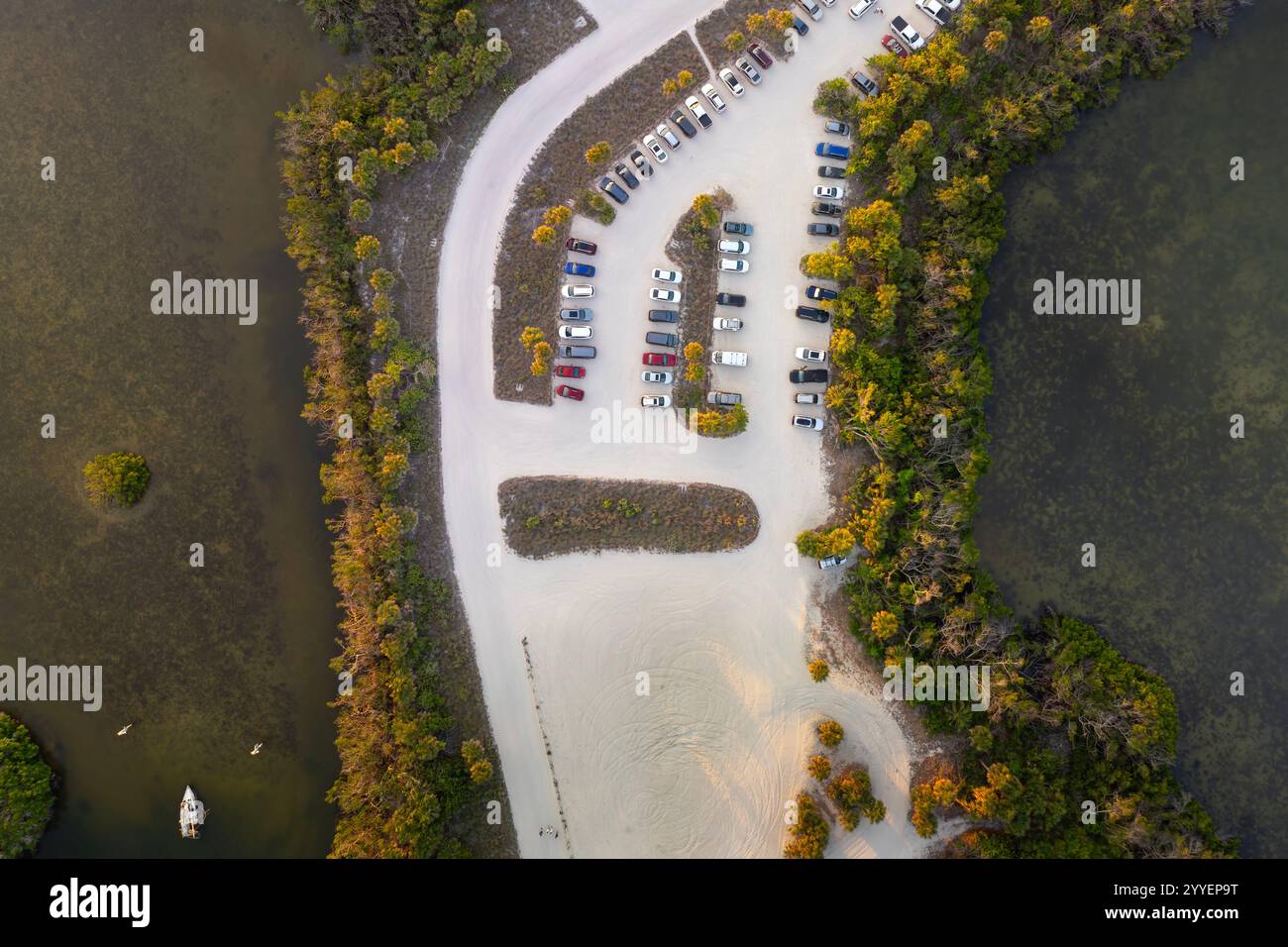 Parking lot for tourists cars in front of ocean beach with soft white ...