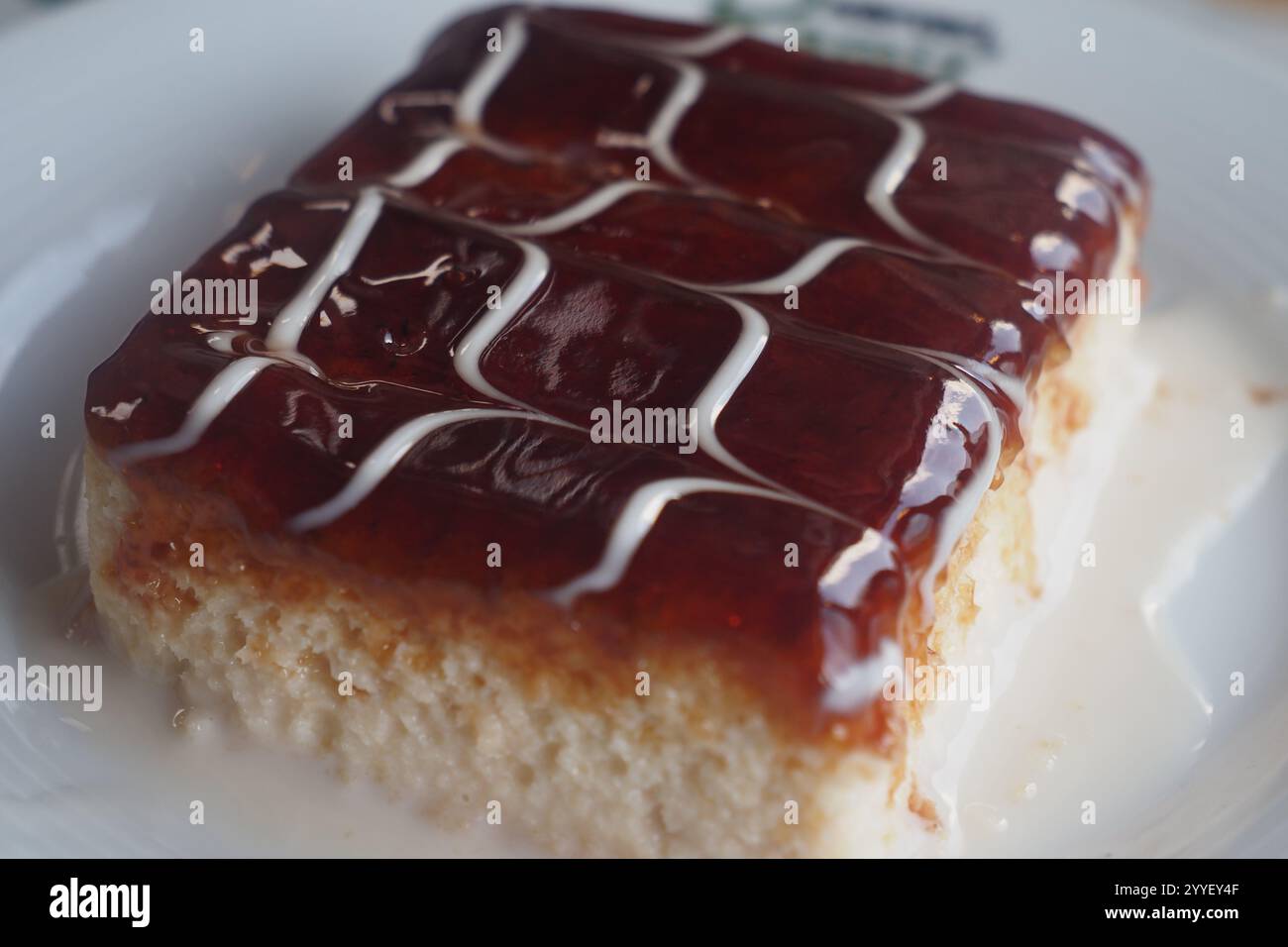 Delicious layered cake with fruit glaze and cream drizzle for dessert ...