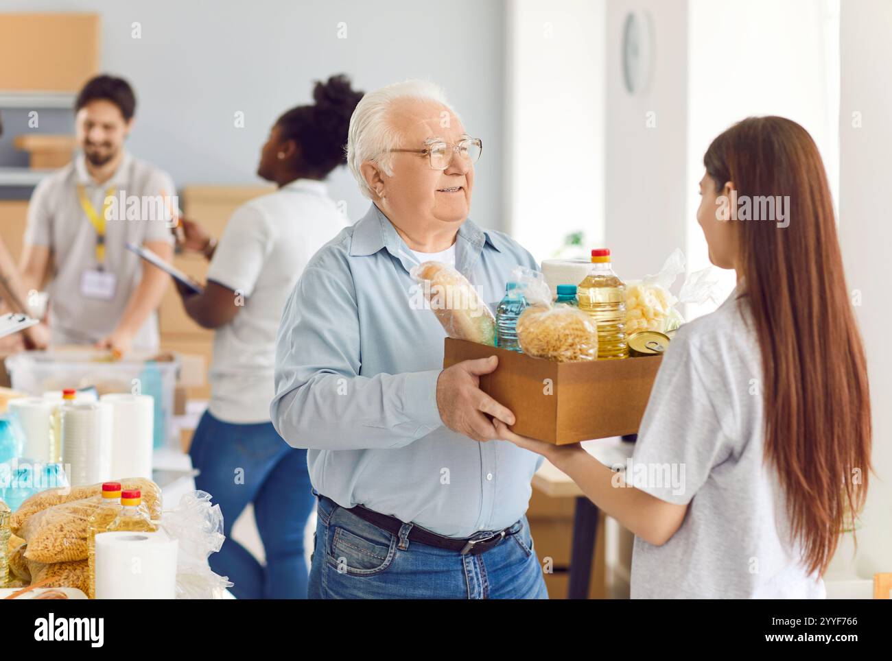 Old woman volunteer giving free hi-res stock photography and images - Alamy