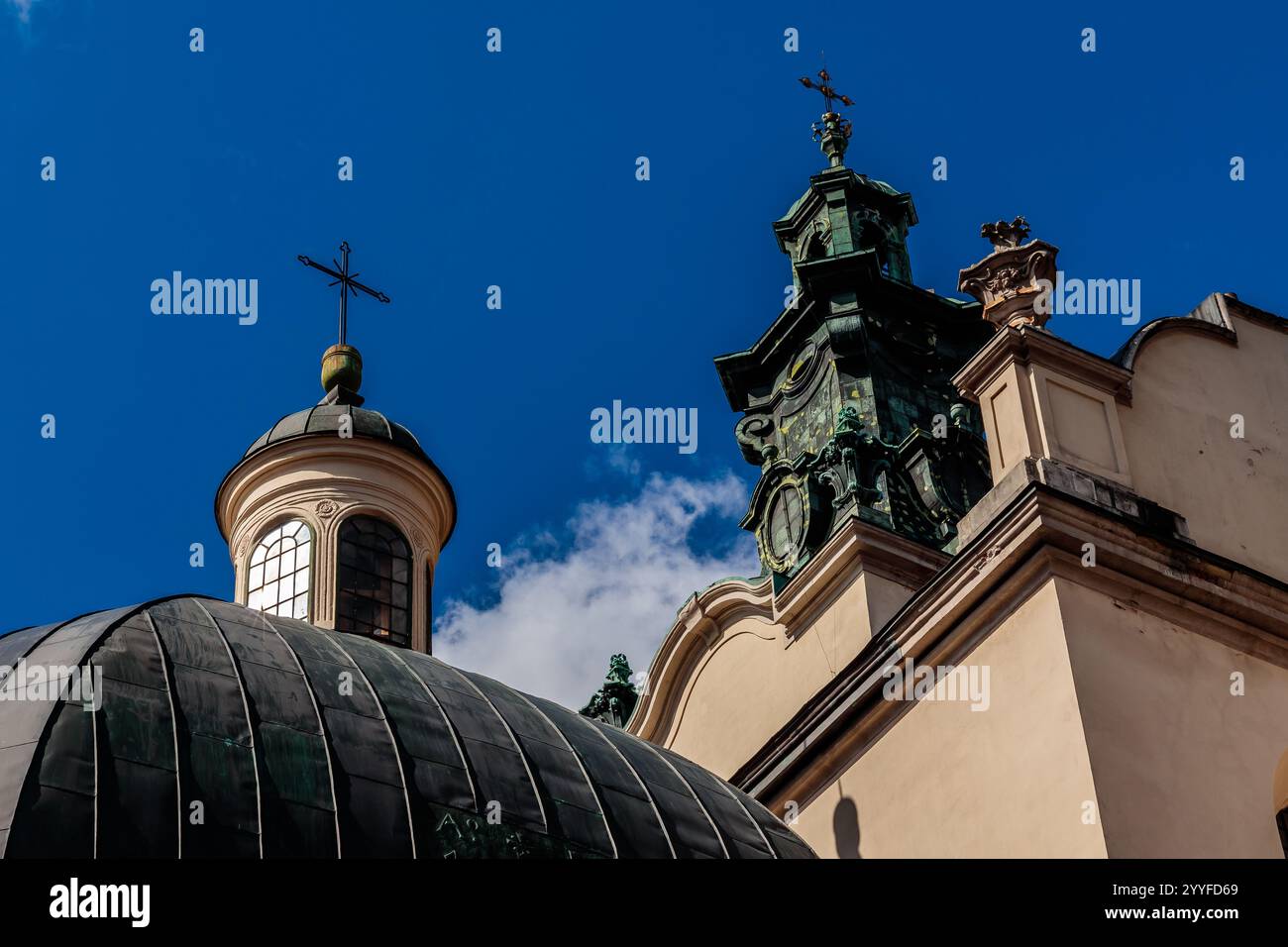 A church with a dome and a cross on top. The dome is green and the ...