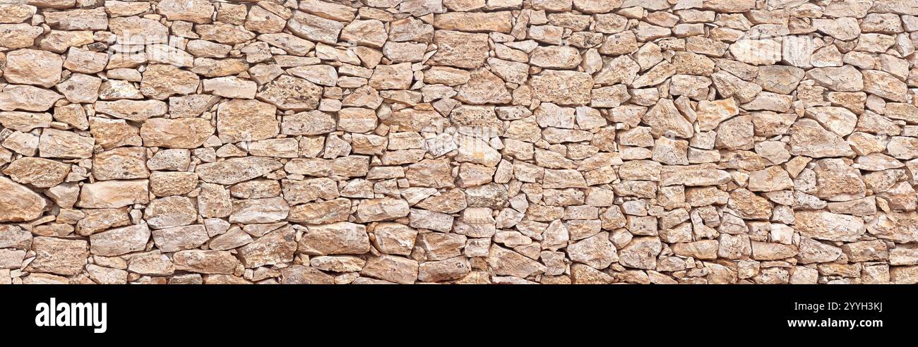 Texture of a stone wall. Old castle stone wall texture background. A stone wall as a background or texture. Stock Photo