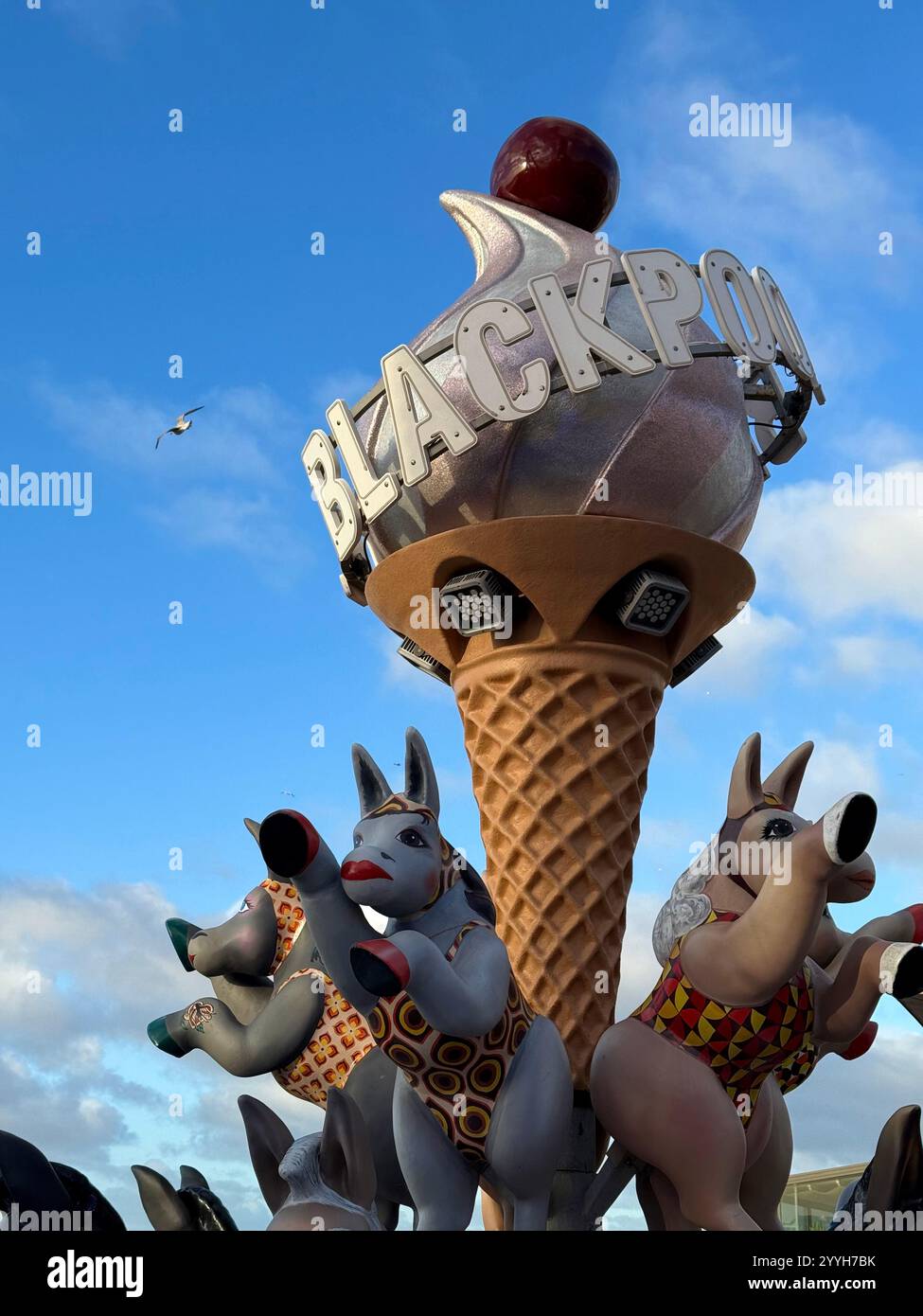 Giant ice cream cone with cherry on top and dancing donkeys sculpture as advert for Blackpool, part of the winter market. - Smartphone Captured Stock Image