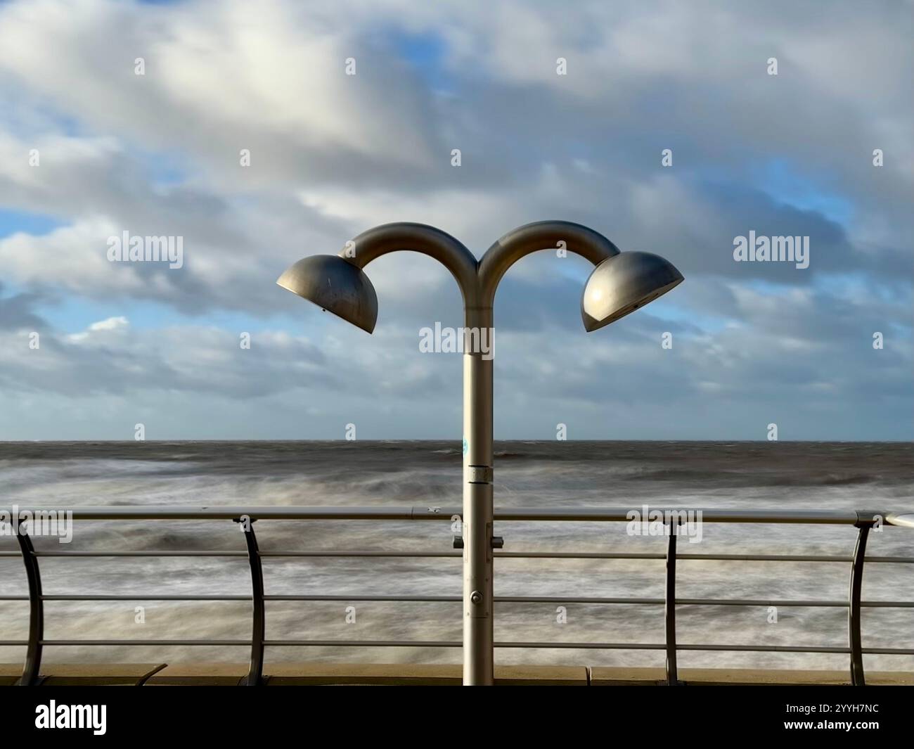 Shower heads on Blackpool promenade with motion blurred sea at high tide in background - Smartphone Captured Stock Image Shower heads on Blackpool promenade with motion blurred sea at high tide in background - Smartphone Captured Stock Image