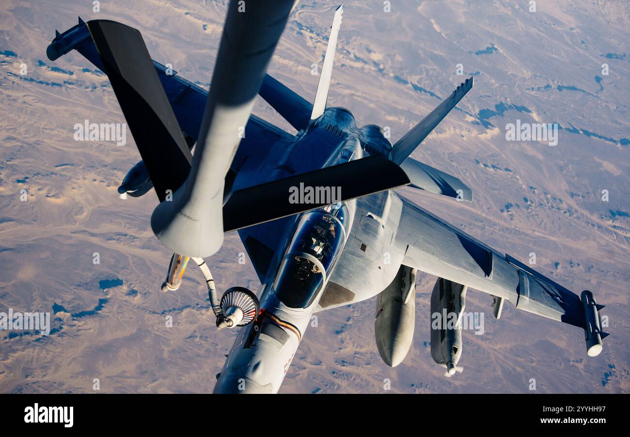 A U.S. Navy EA-18 Growler refuels from a 28th Expeditionary Aerial Refueling Squadron KC-135 Stratotanker during a mission in support of Operation Fre Stock Photo