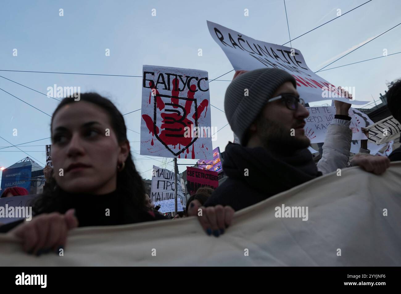 People attend a protest against the Serbian authorities in Belgrade ...