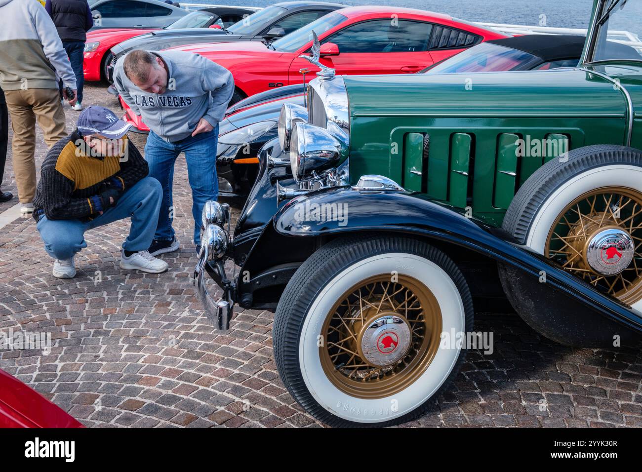 Men looking at a classic 1930s American Packard at an American Car Club ...