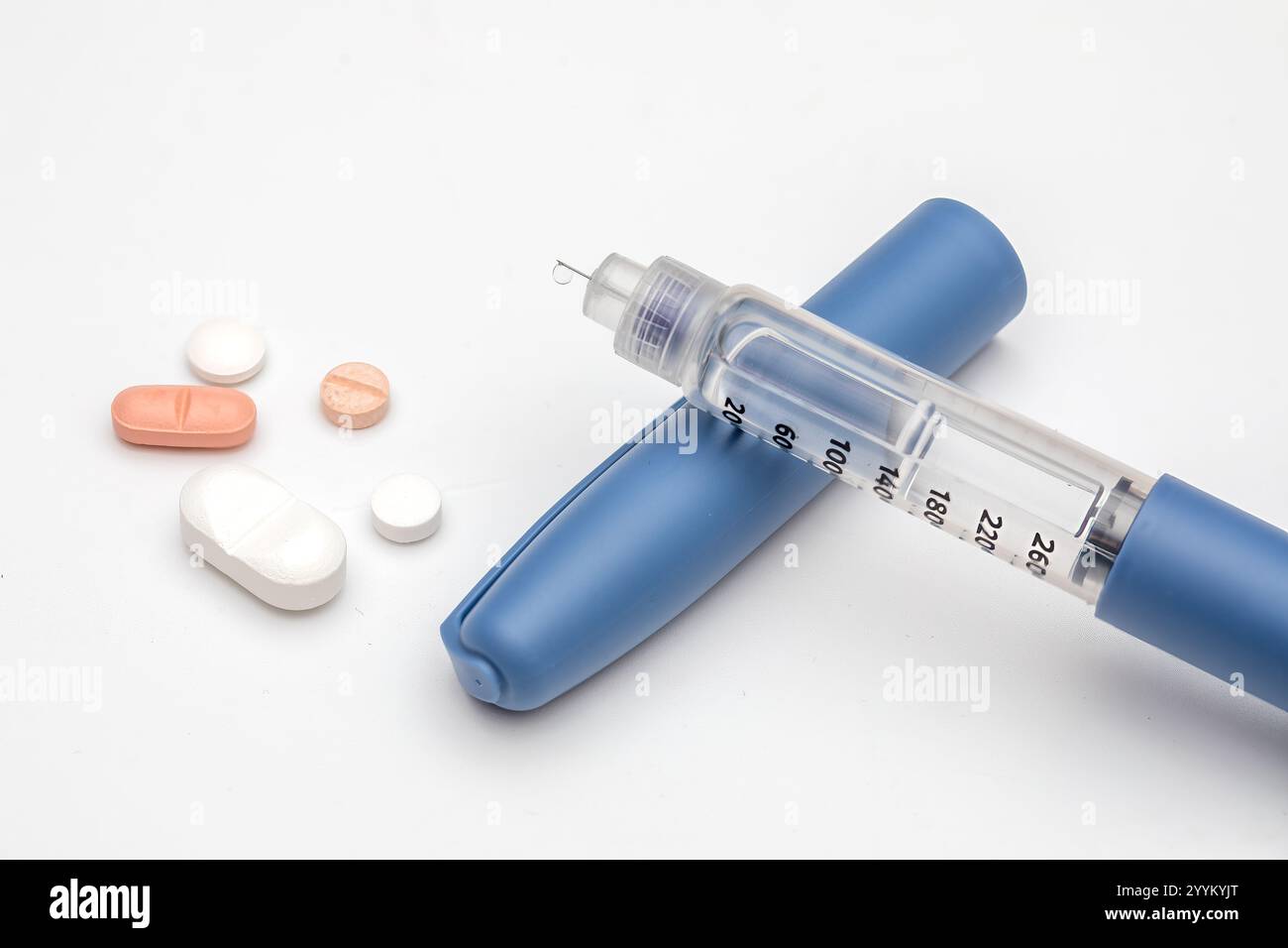 Closeup of Insulin Pen and Diabetes Pills for Diabetes Management and Treatment Stock Photo
