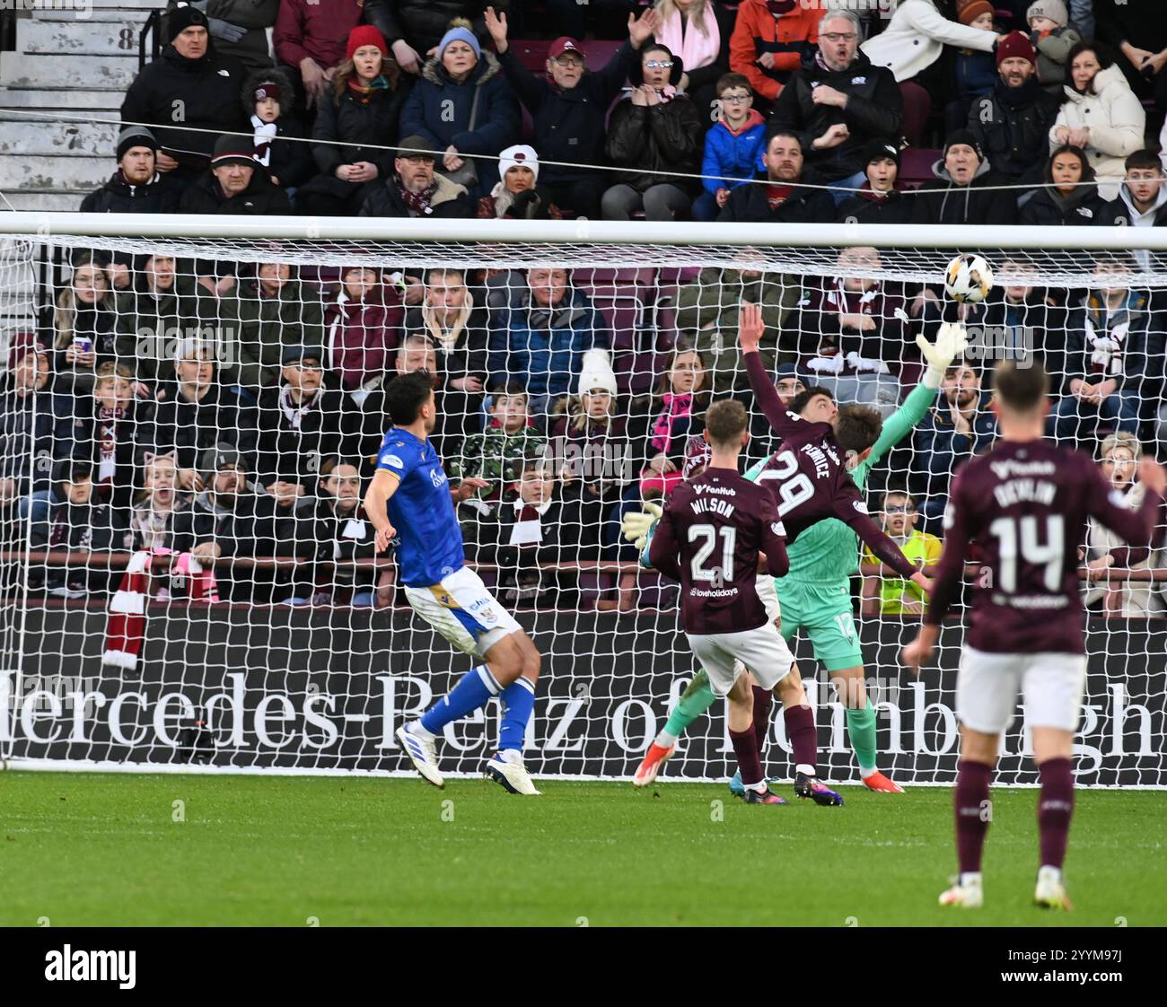 Tynecastle Park, Edinburgh.Scotland UK.22nd Dec 24 William Hill Scottish Premiership match Hearts vs St Johnstone. James Penrice of Hearts heads home the opening goal past St Johnstone goalkeeper Josh Rae in the 2-1 victory for Hearts Credit: eric mccowat/Alamy Live News Stock Photo