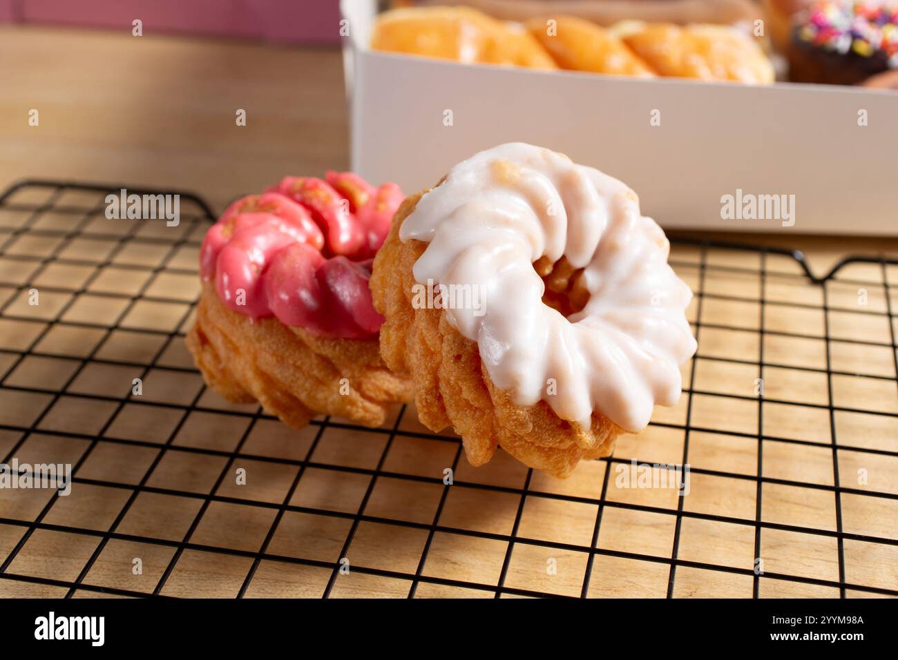 A view of some frosted cruller donuts. Stock Photo