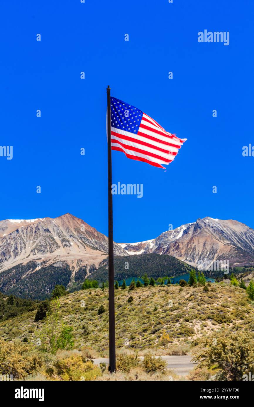 A flag pole with a red, white and blue American flag flying in the air ...