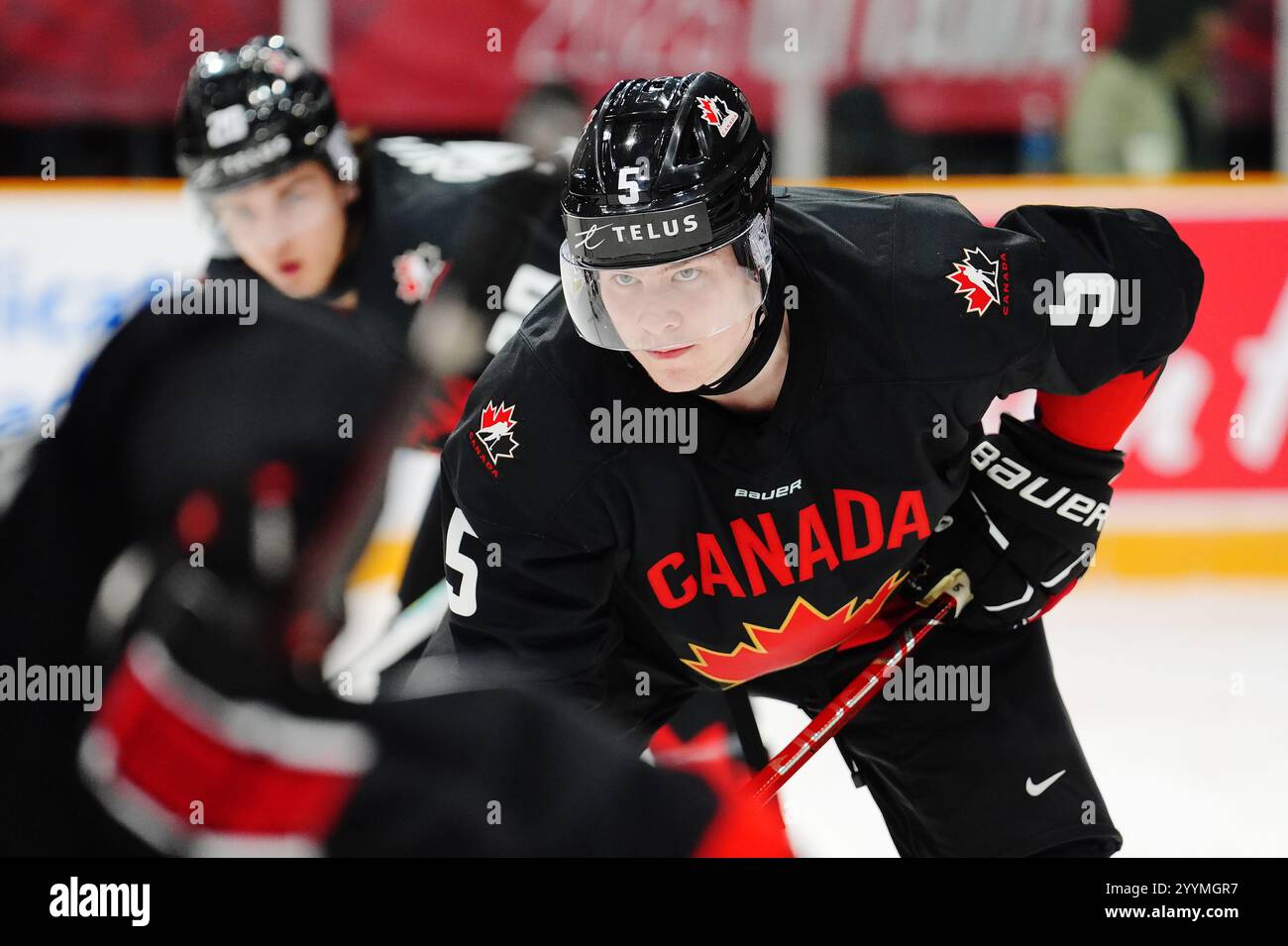 Canada's Oliver Bonk (5) lines up for a face off against Switzerland