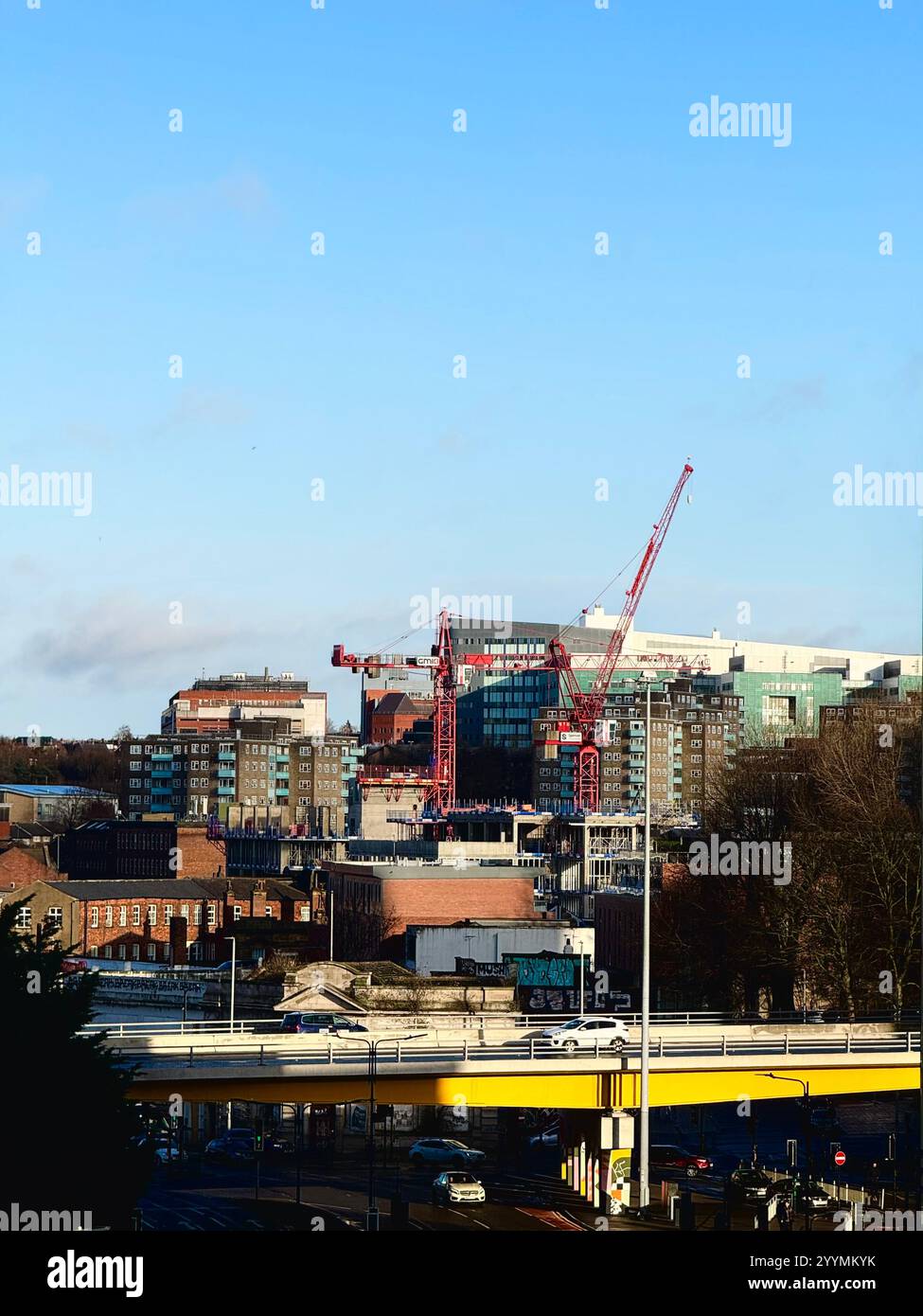 Aerial view of Leeds City Centre skyline with various tower buildings surrounding the town centre in West Yorkshire on a blue sky sunny day. Stock Photo