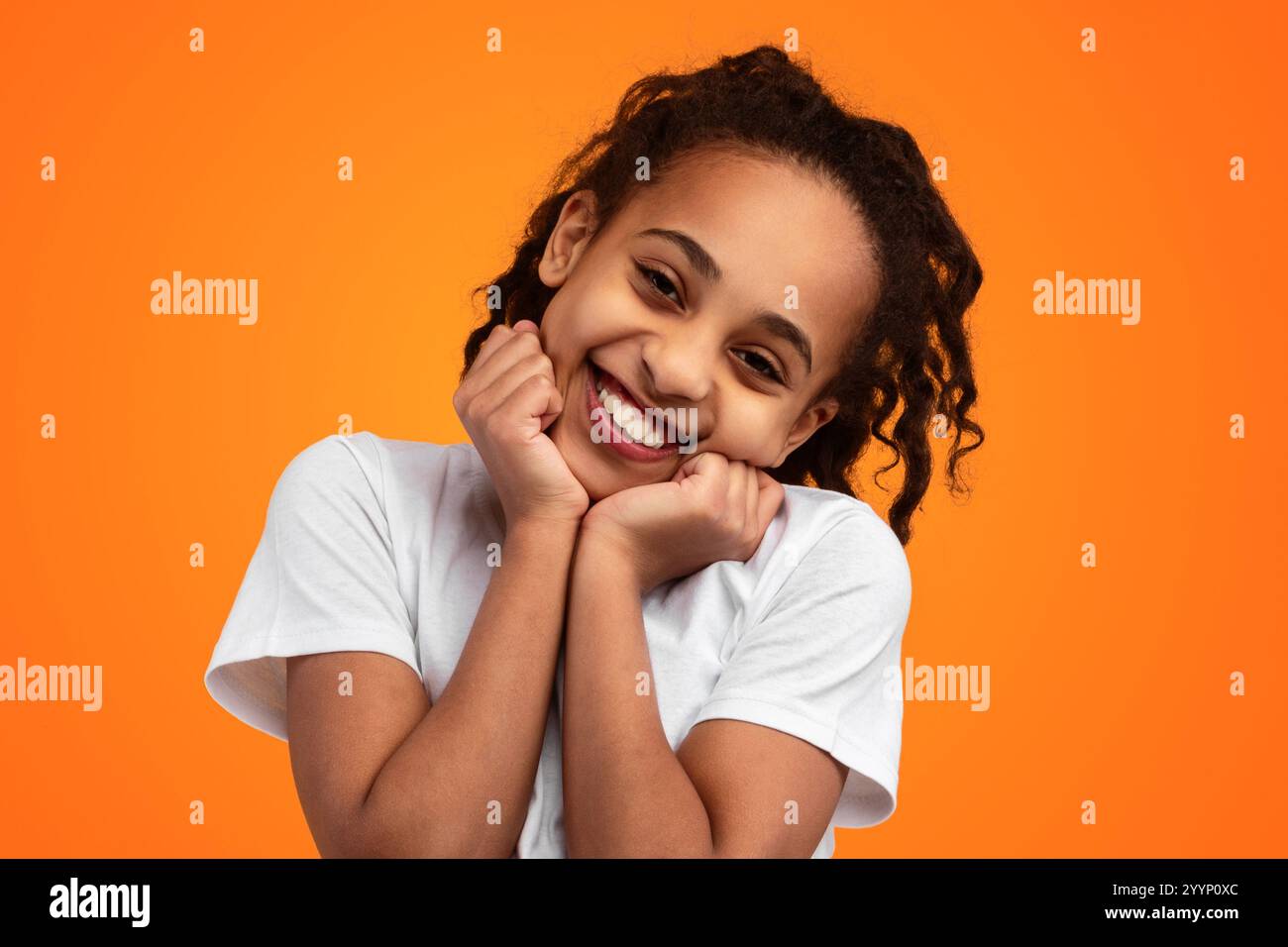 Cute Joyful African American Girl Touching Cheeks Stock Photo - Alamy