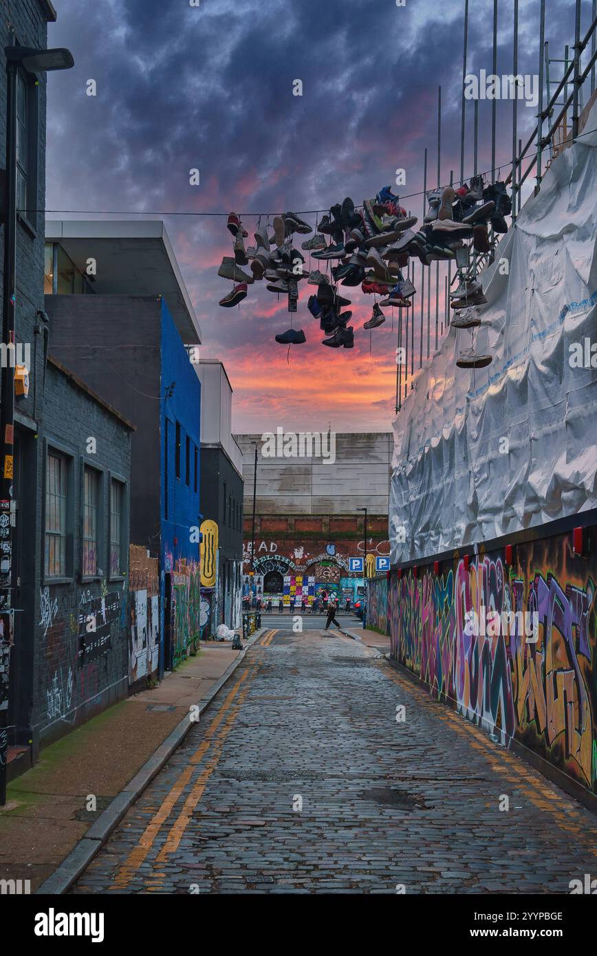 Cobblestone Street in London with Graffiti and Hanging Shoes Stock ...