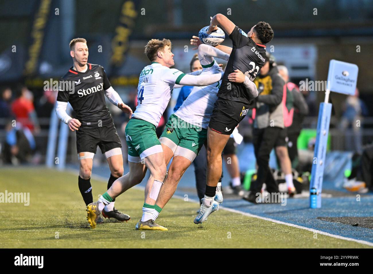 Brandon Jackson of Saracens releases the ball as he is challenged by ...
