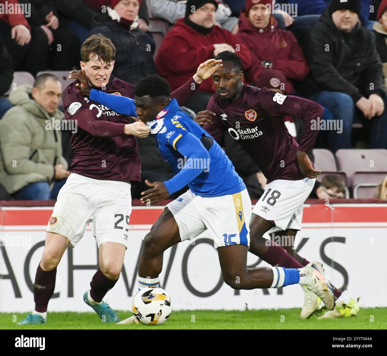 Tynecastle Park, Edinburgh.Scotland UK.22nd Dec 24 William Hill Scottish Premiership match Hearts vs St Johnstone. James Penrice of Hearts tussle with Adama Sidibeh of St Johnstone looking Malachi Boateng of Hearts Credit: eric mccowat/Alamy Live News Stock Photo