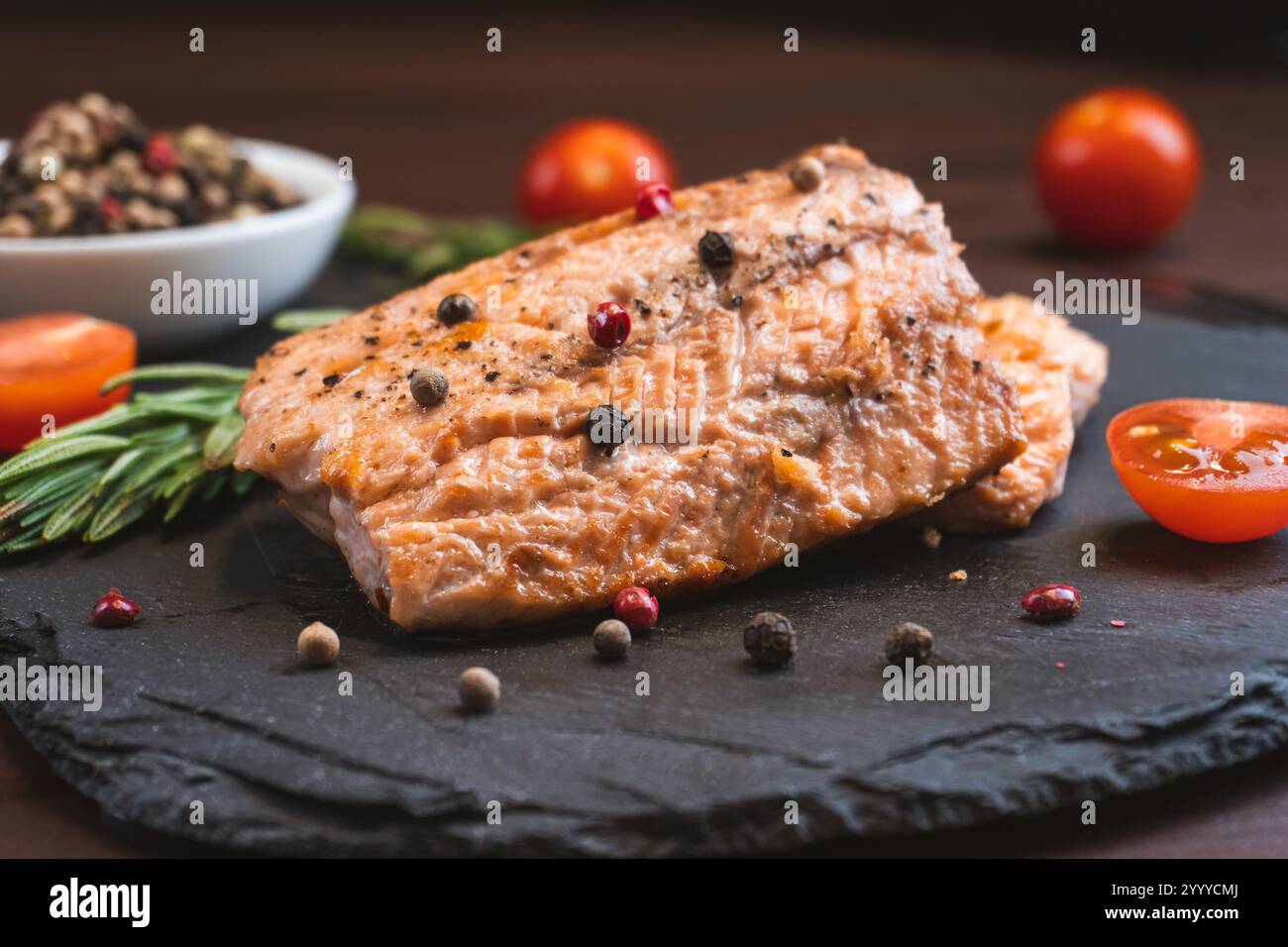 Grilled red fish meat salmon steak with tomato rosemary and spices on ...