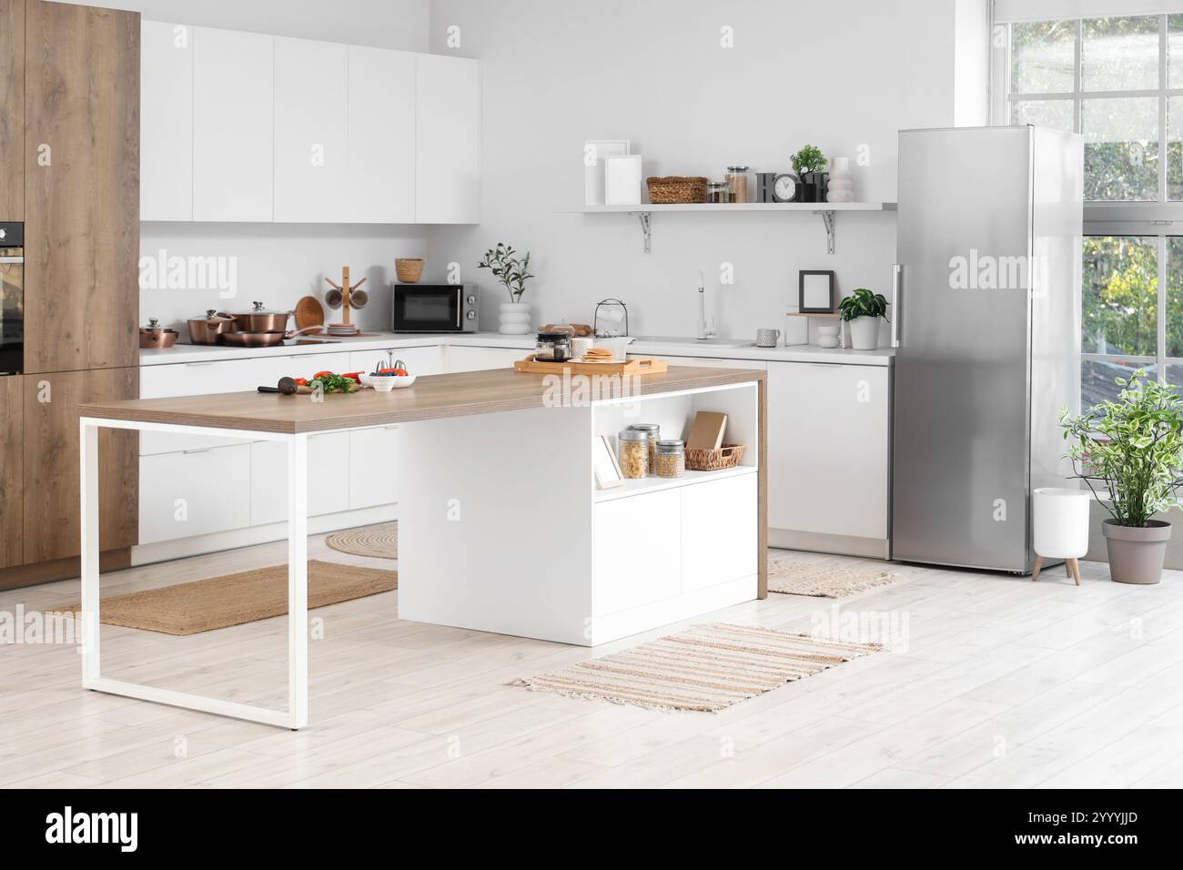 Interior of stylish kitchen with modern fridge and island table Stock ...
