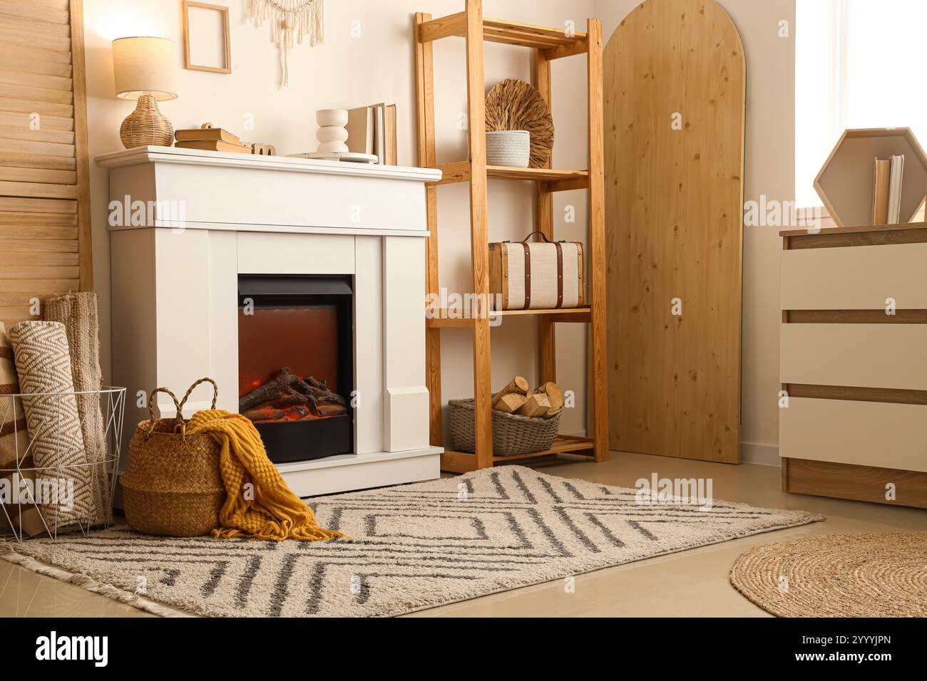 Interior of cozy living room with fireplace, shelving unit and dresser ...