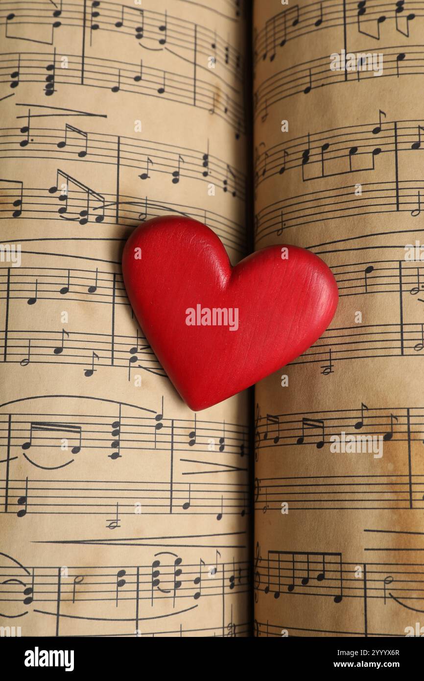 Heart figure on musical note sheets, closeup Stock Photo