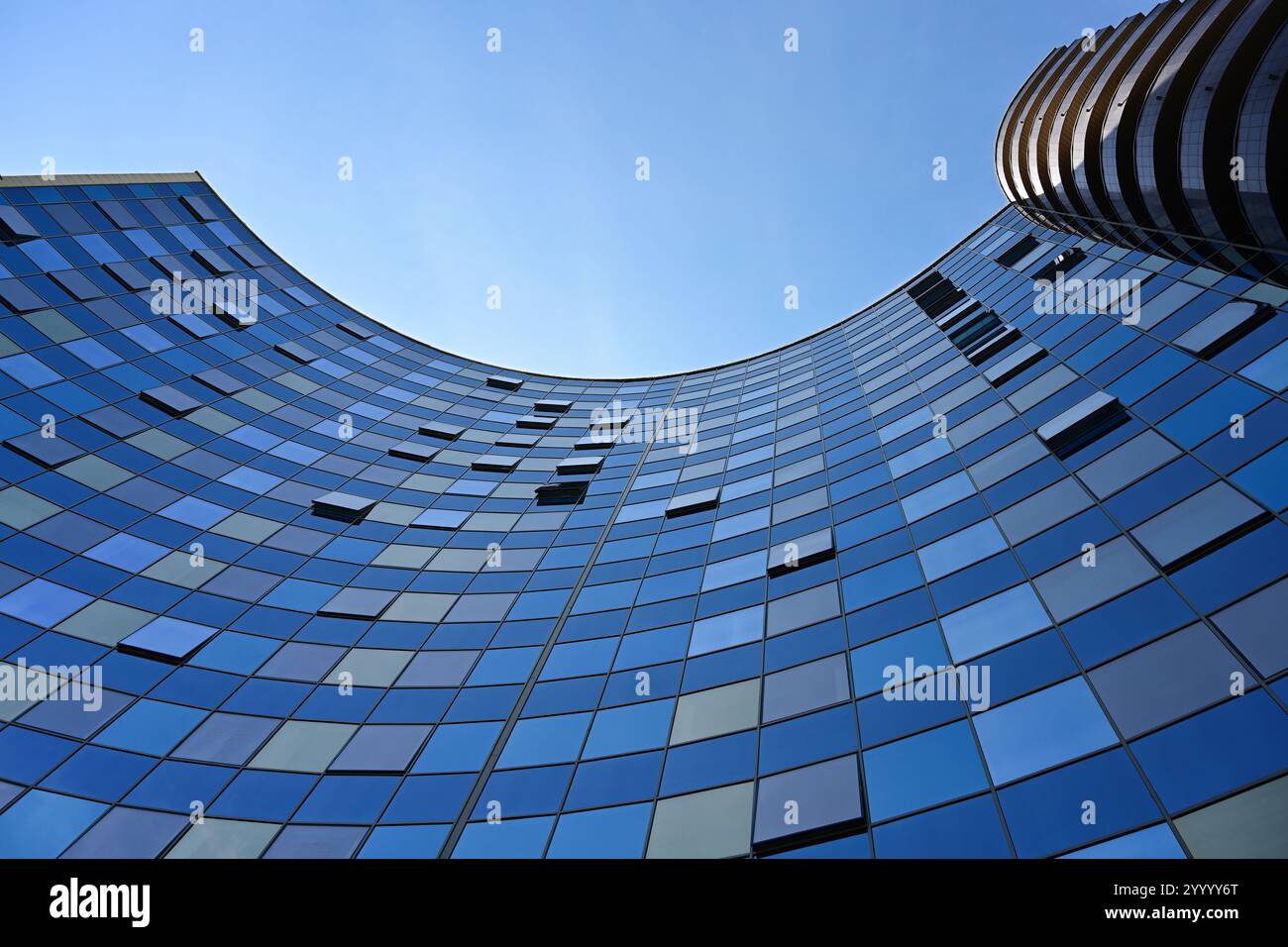 Glass facade of modern office building on a blue sky background Stock ...