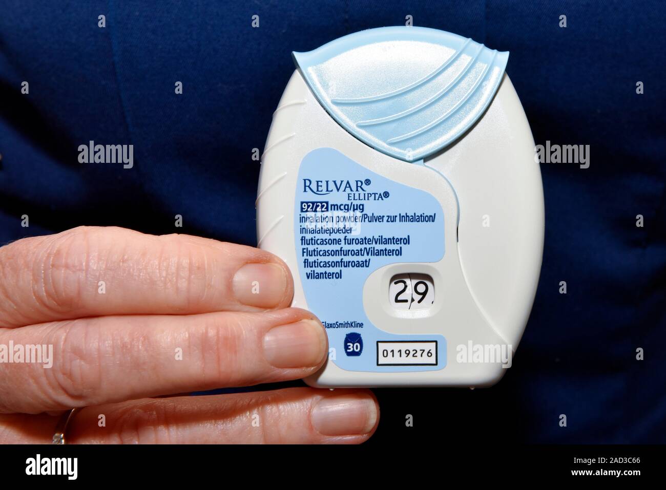 Asthma inhaler. Nurse holding an inhaler used to deliver the