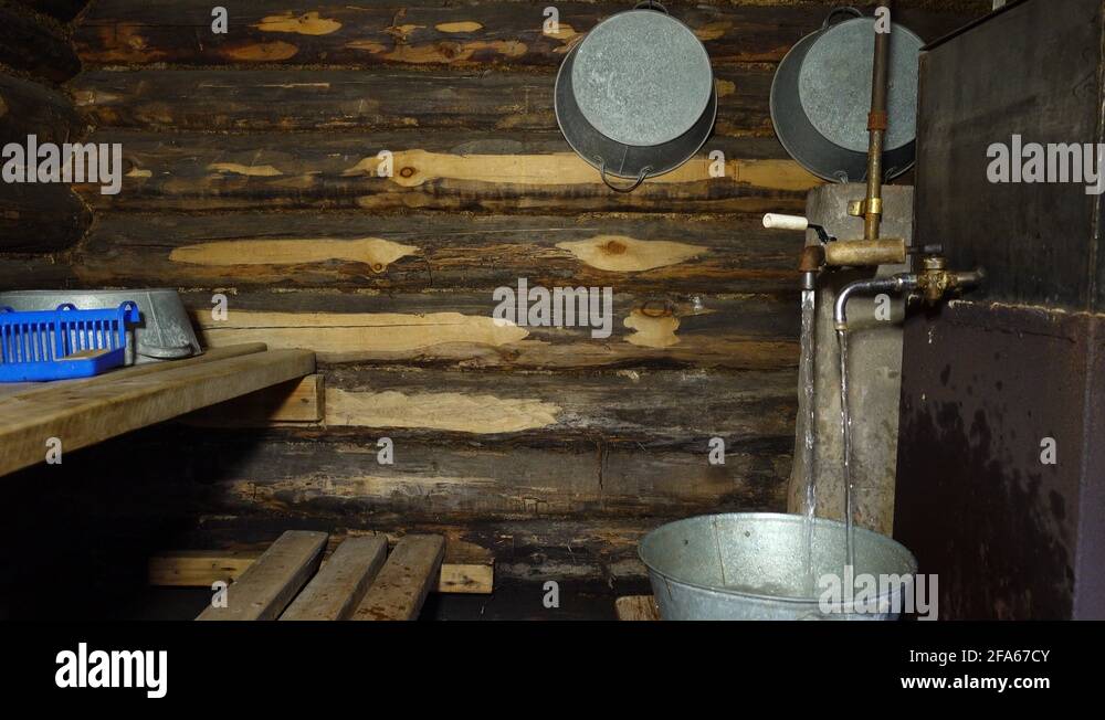 Interior of the Russian bath. Water is pouring from the tap into the