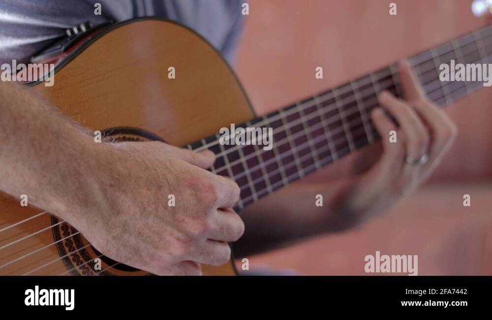 Acoustic guitar. Guitarist playing music. Close up finger picking Stock