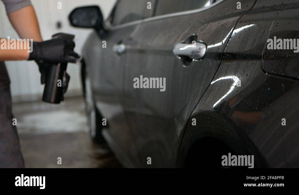 man waxing a black car at car wash Stock Video Footage Alamy