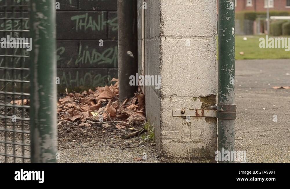 Closing a gate in urban park Stock Video Footage Alamy
