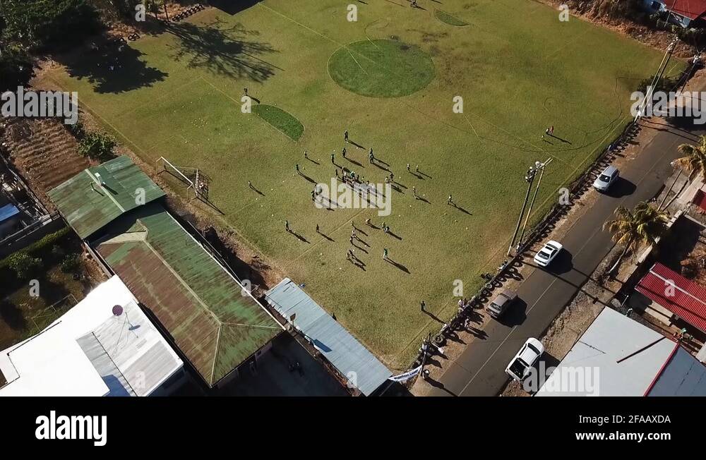 Costa Rican kids playing soccer on a soccer field in Costa Rica Stock