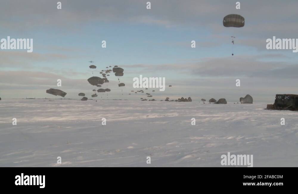 Paratroopers pack their parachutes after jump from military aircraft