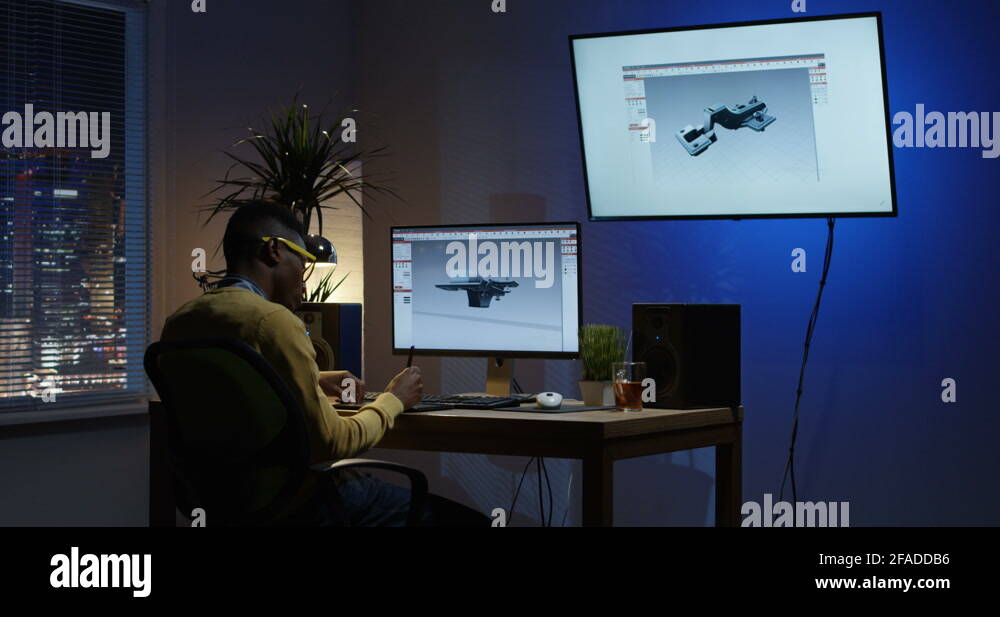 Young man sitting back and editing an 3D model on his computer Stock ...