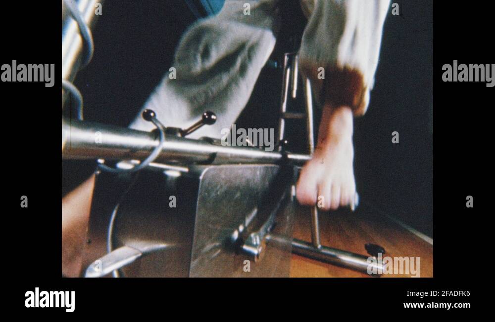 1960s Feet pedaling stationary bike. Man jumping on trampoline. Man