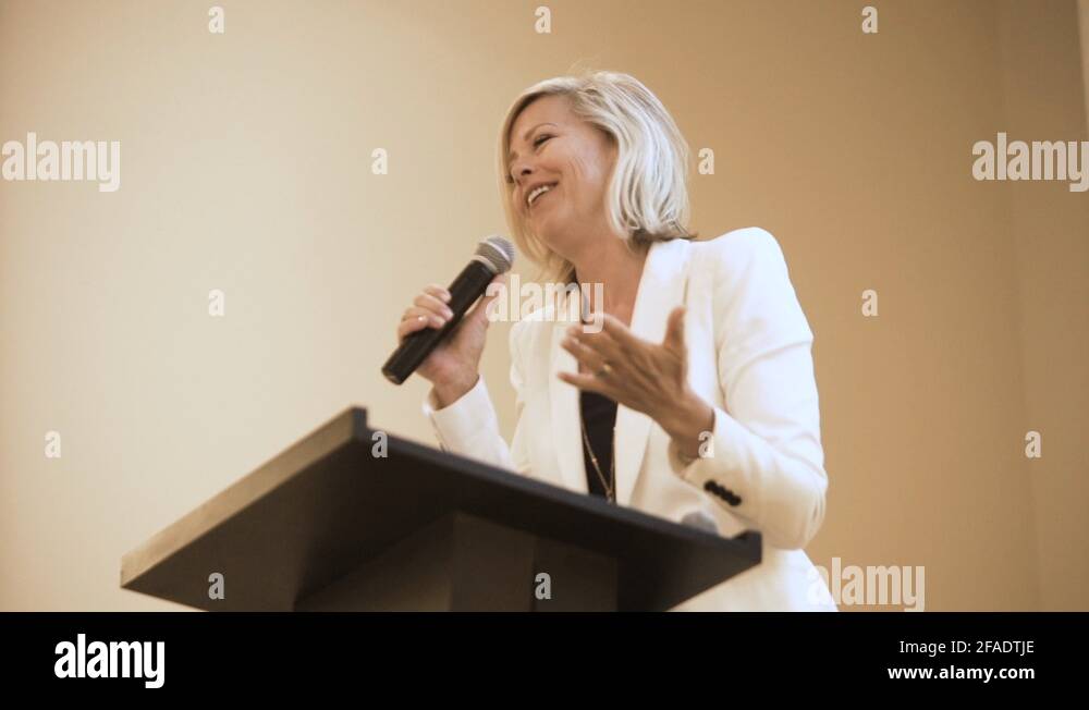 Beautiful woman speaking at a podium at a conference Stock Video