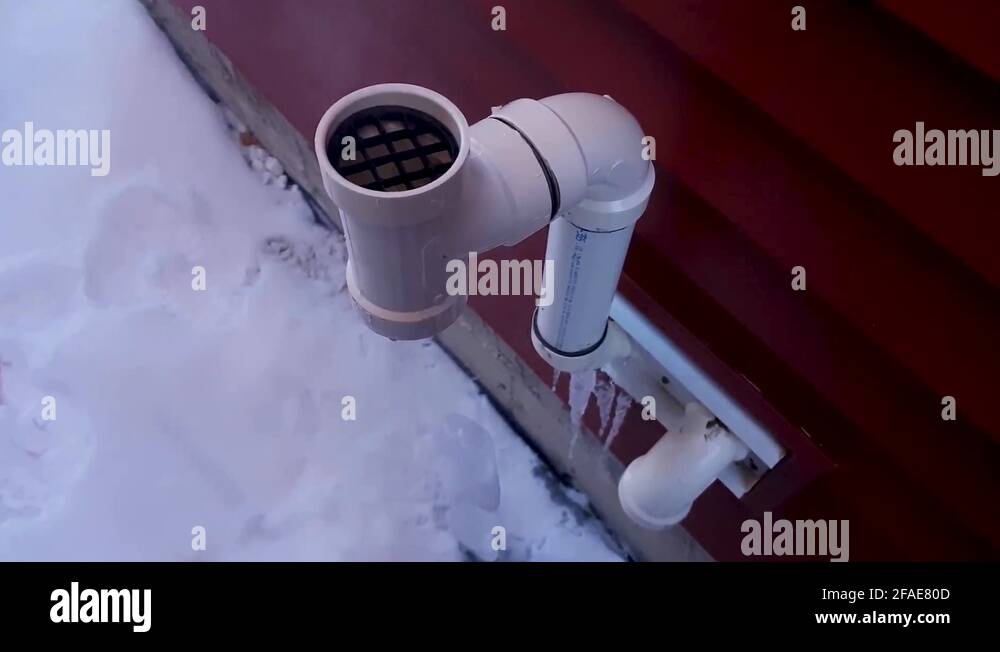 Icicle forming due to vapor coming out of house exhaust pipe, with