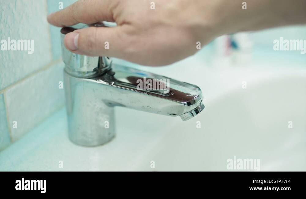 Using tap water in the bathroom sink Stock Video Footage Alamy