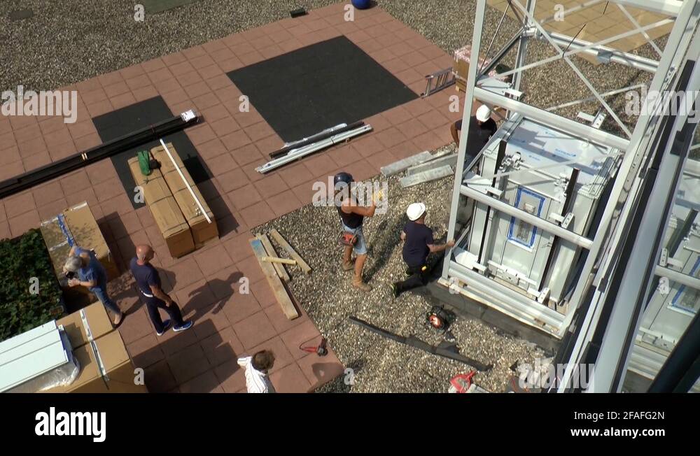 Construction Workers Installing And Positioning A Lift Shaft, Tilt Up Stock Video Footage Alamy