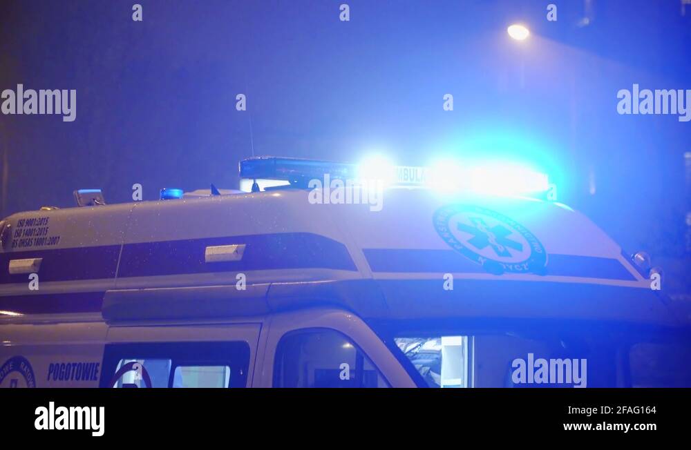Blue flashing lights of an ambulance emergency service vehicle at an