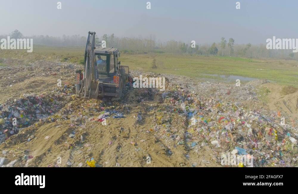 Garbage dumping using JCB Machine at the Solid Waste Management Plant