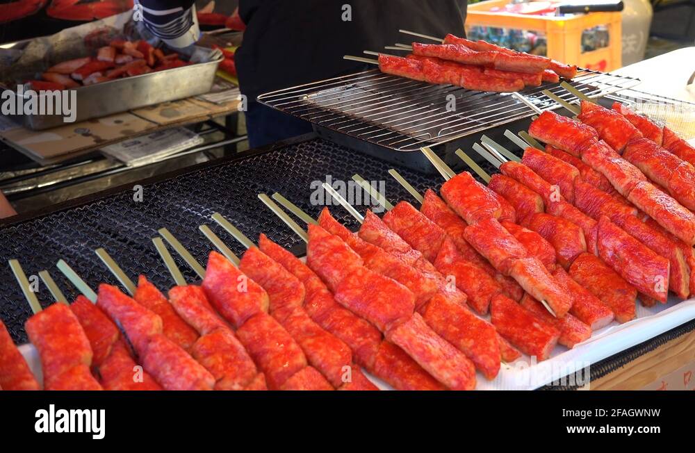 Grilling of crab sticks (surimi) on a street food court. Tokyo Stock