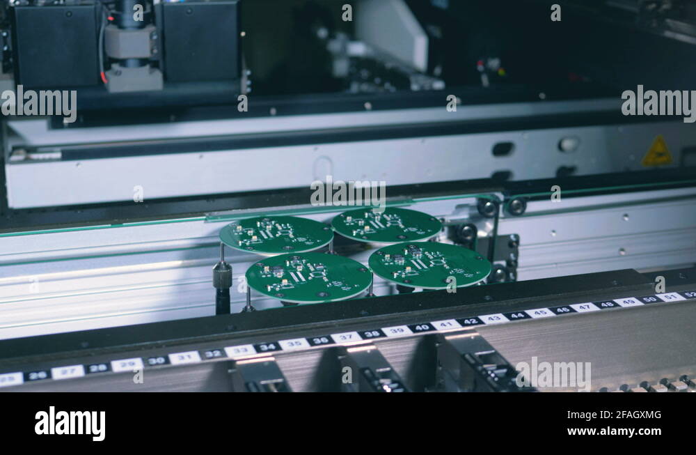 High-tech machine is adding microchips to green boards Stock Video