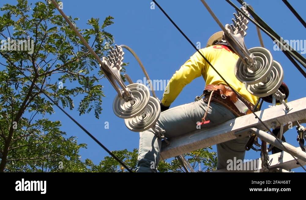 Lineman Fixing Some Parts of the Transmission Lines, Philippines Stock
